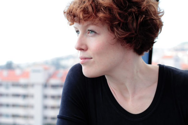 Image of Sissel Marie Tonn looking off into distance next to window